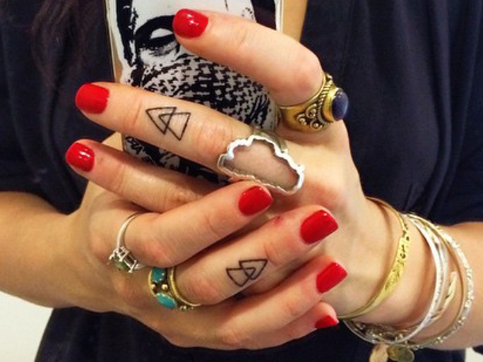 Black Outline Two Triangle Tattoo On Girl Finger
