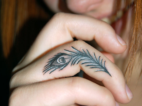Black Peacock Feather Tattoo On Side Finger