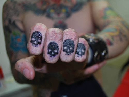Black Skulls Knuckles Tattoos On Left Hand