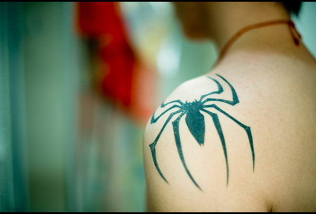Black Spiderman Logo Tattoo On Left Shoulder