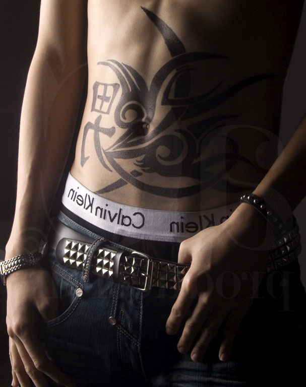 Black Tribal Design Tattoo On Man Stomach