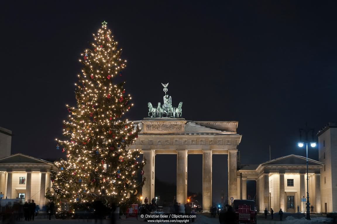 Brandenburg Gate With A Christmas Tree At Night In Berlin, Germany