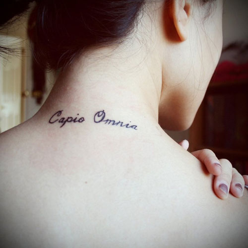 Capio Omnia Words Tattoo On Girl Back Neck