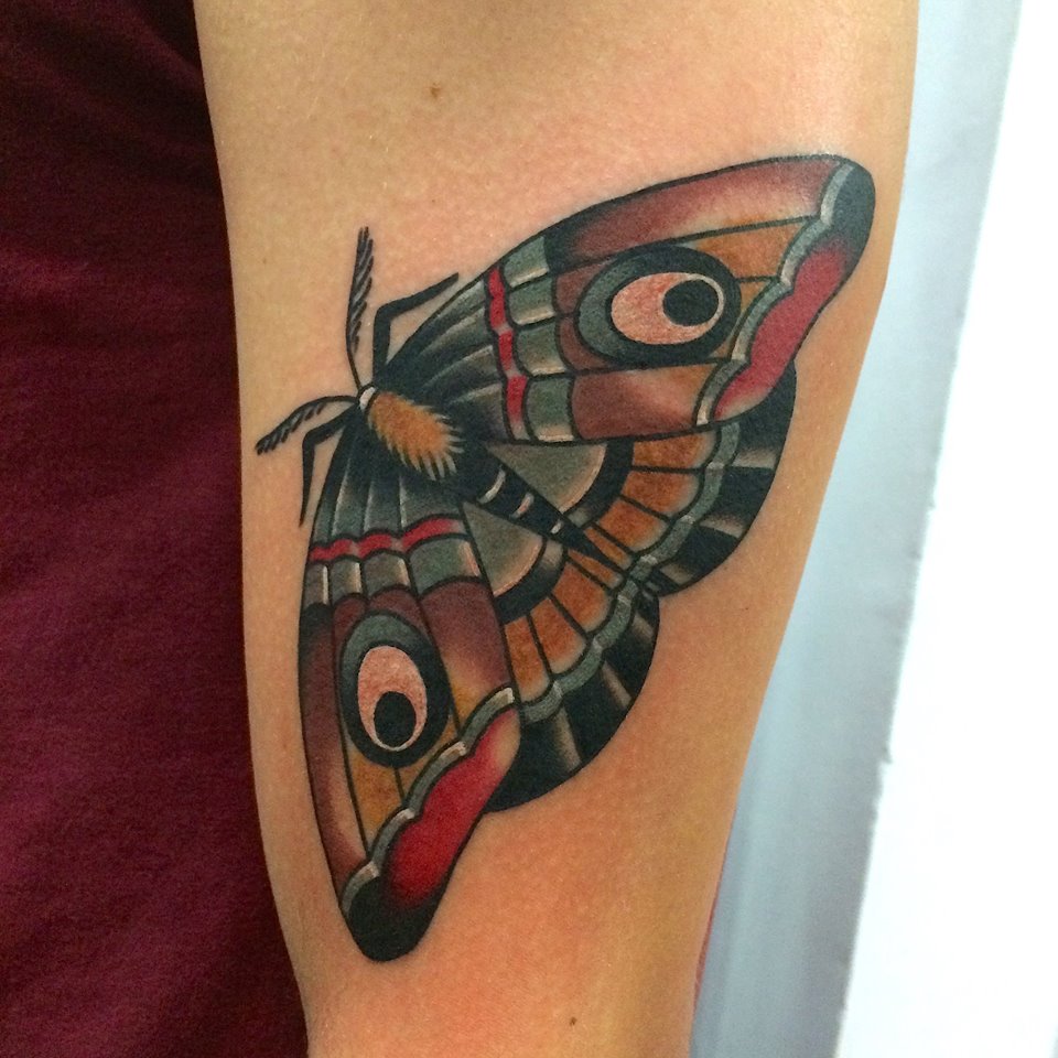 Colored Moth Tattoo On Left Bicep by Fabio Onorini