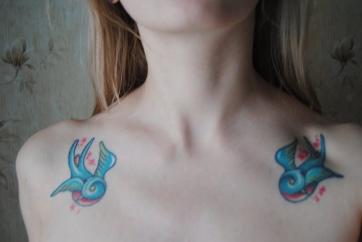 Colorful Flying Birds Tattoo On Girl Collar Bone