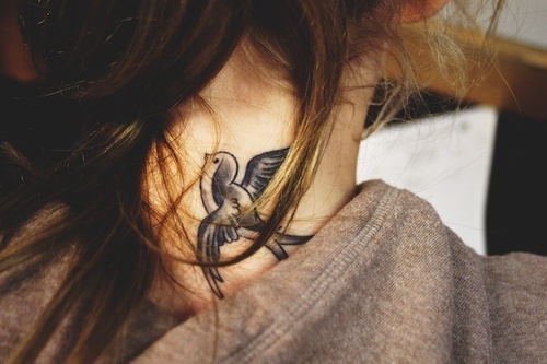 Cute Black Ink Bird Tattoo On Girl Back Neck