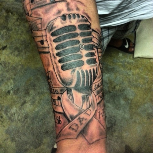 Dad Ribbon And Microphone Tattoo On Forearm