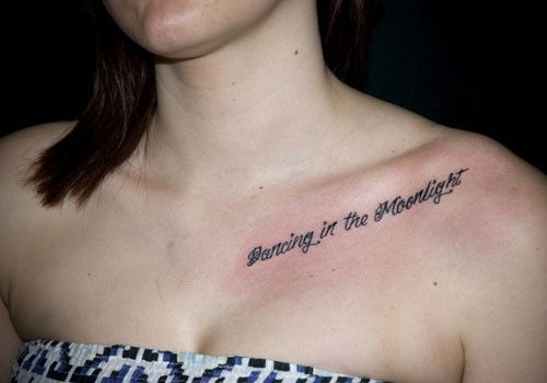 Dancing In The Moonlight Lettering Tattoo On Girl Collar Bone