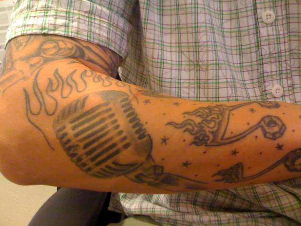 Flaming Music Note And Microphone Tattoo On Right Sleeve