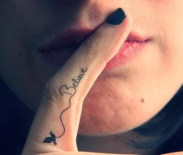 Flying Bird With Believe Lettering Tattoo On Girl Finger