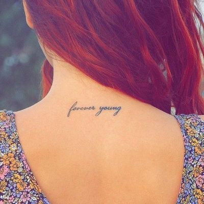 Forever Young Words Tattoo On Girl Back Neck