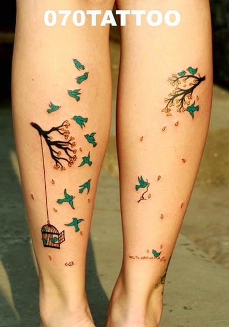 Green Flying Birds And Cage Tattoos On Back Legs