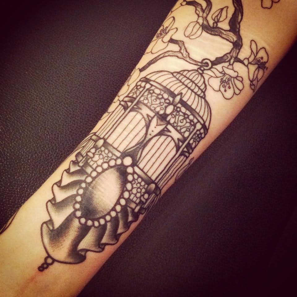 Grey Ink Cage Tattoo On Forearm