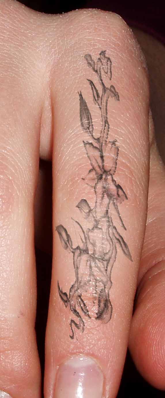 Grey Ink Flowers Tattoo On Finger