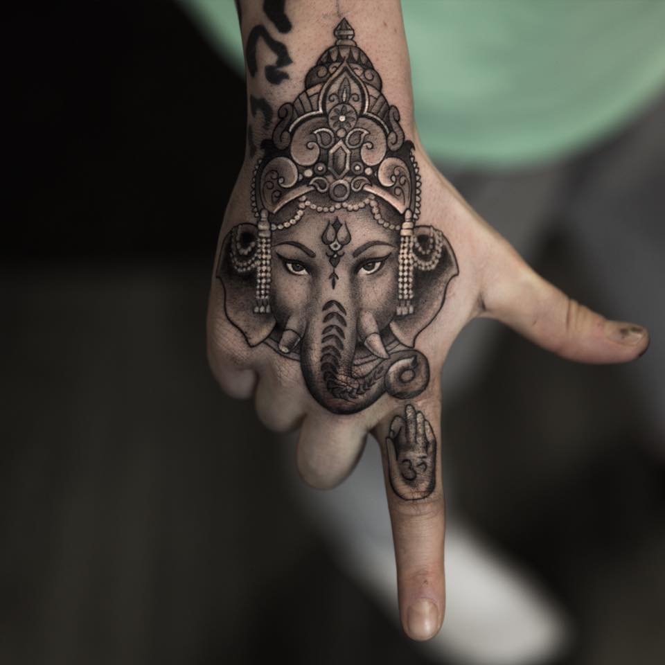 Grey Ink Ganesha Tattoo On Right Hand by Niki Norberg
