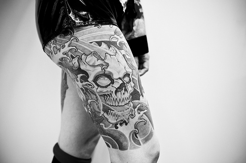 Grey Ink Gothic Skull Tattoo On Girl Right Thigh