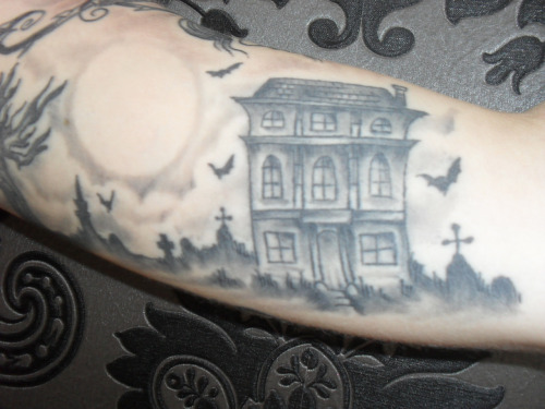 Grey Ink Haunted House Tattoo On Bicep