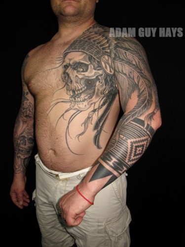 Grey Ink Indian Chief Skull Head Tattoo On Man Left Chest And Sleeve