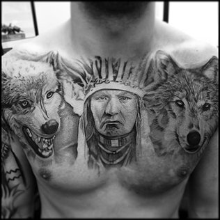 Grey Ink Indian Chief With Two Wolf Tattoo On Man Chest By Josh Hobden
