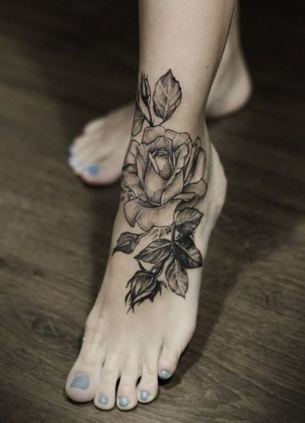 Grey Ink Rose Tattoo On Girl Left Foot