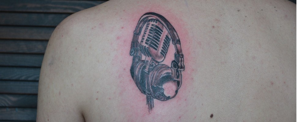 Left Back Shoulder Grey Ink Microphone And Headphone Tattoo