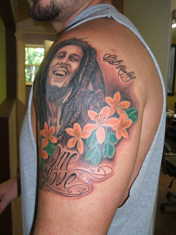 Left Shoulder Flowers And Bob Marley Tattoo