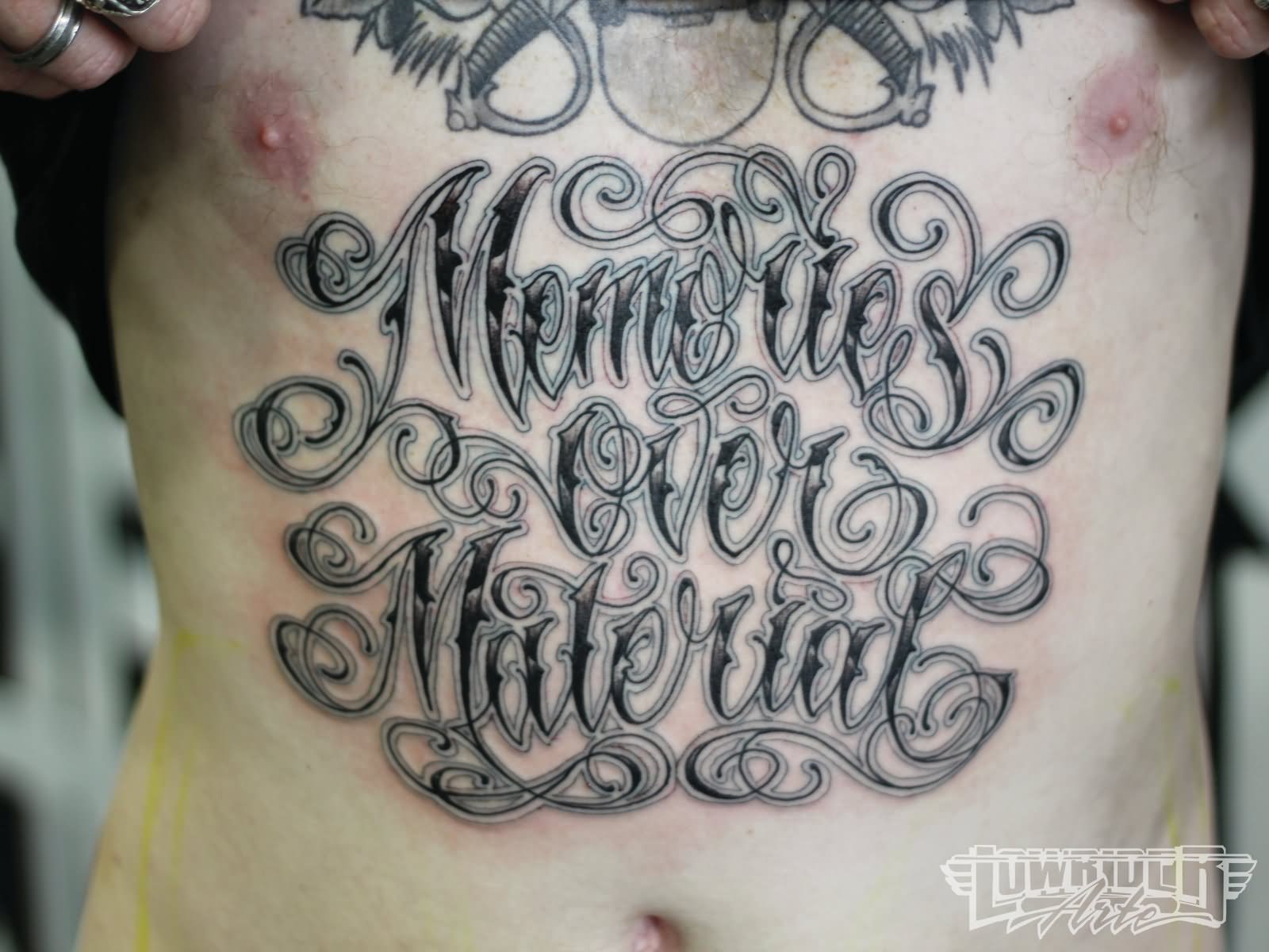 Memories Over Material Lettering Tattoo On Man Stomach