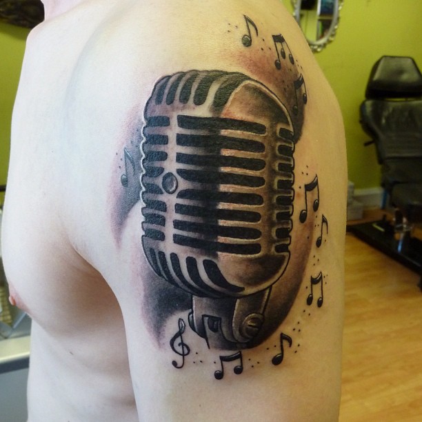 Microphone And Music Notes Tattoo On Left Shoulder