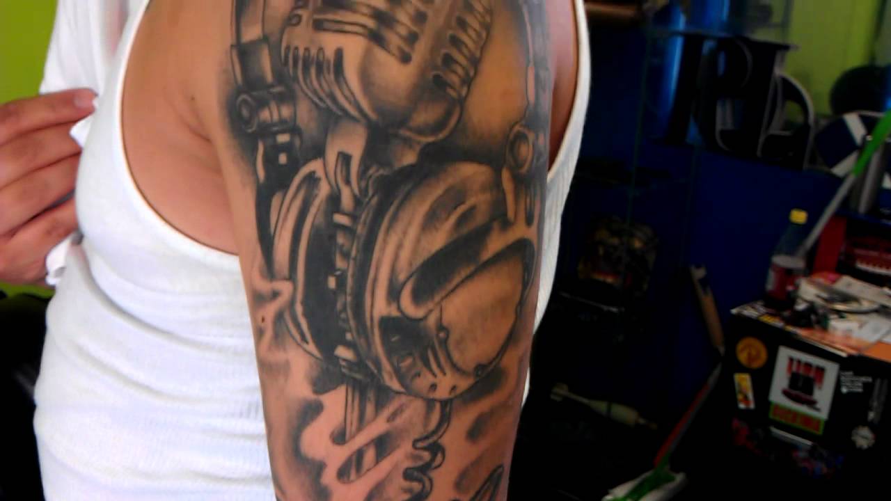 Nice Grey Ink Microphone And Headphone Tattoo On Man Left Half Sleeve