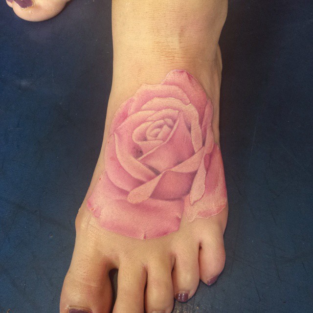 Pink Ink Rose Tattoo On Girl Left Foot