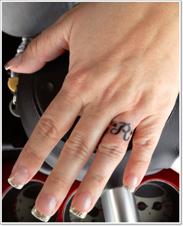 R Letter Tattoo On Girl Finger