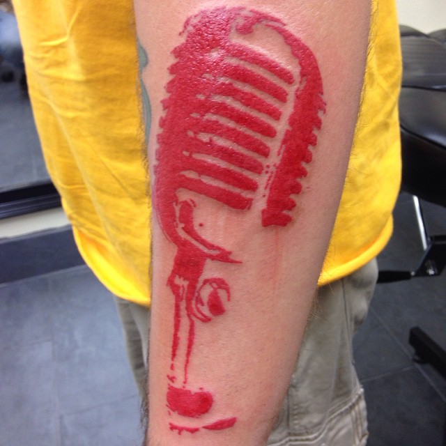 Red Ink Microphone Tattoo On Left Sleeve