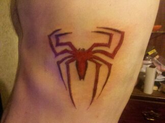Red Ink Spiderman Logo Tattoo On Side Rib by Cole Merritt