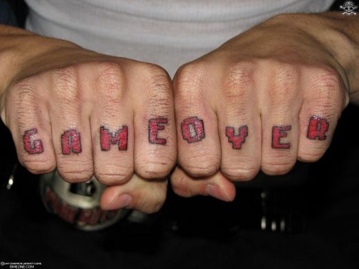 Red ink Game Over Knuckle Tattoo