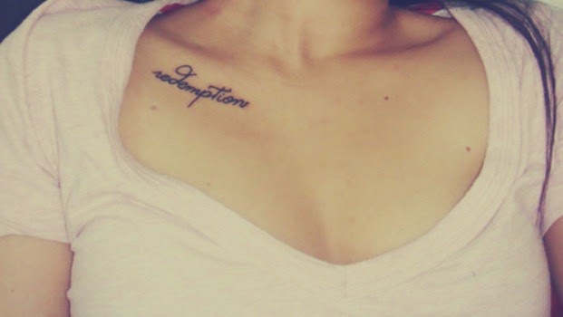 Redemption Lettering Tattoo On Girl Collarbone