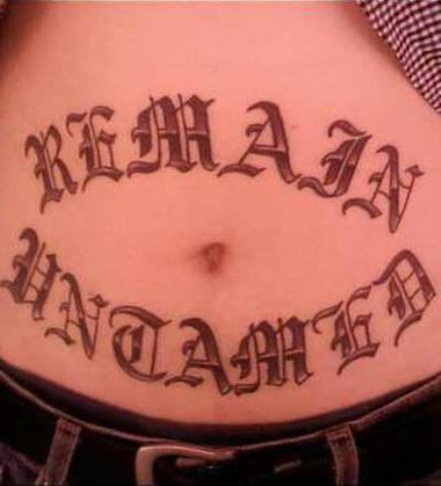 Remain Untamed Lettering Tattoo On Stomach