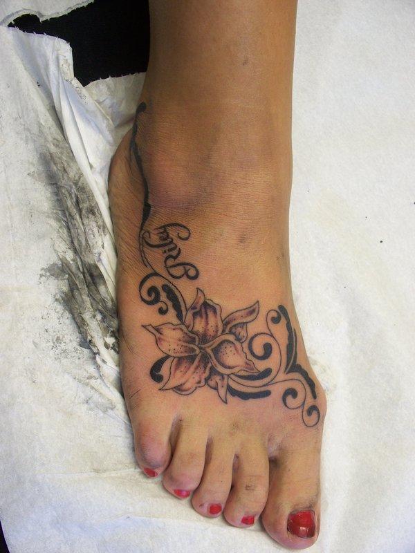 Riley - Black Ink Flower Tattoo On Girl Right Foot