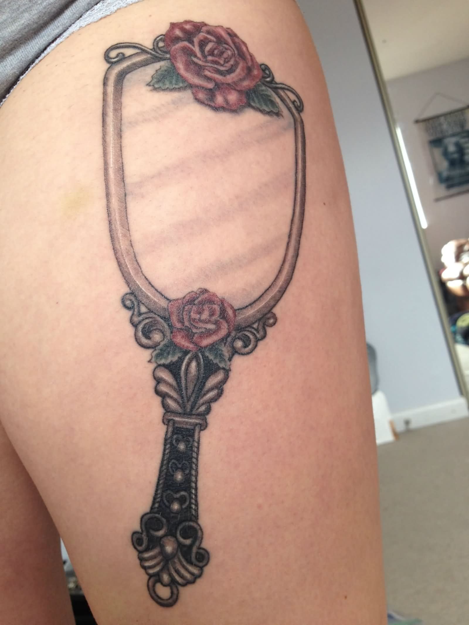 Rose Flowers And Hand Mirror Tattoo On Side Thigh
