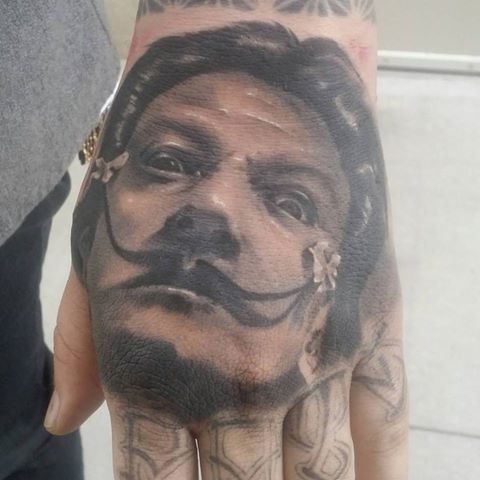 Salvador Dali Portrait Tattoo On Left Hand by Daniel James Walker