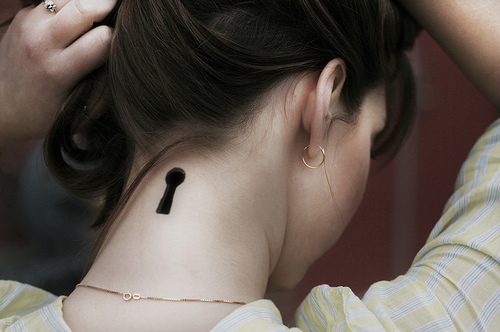 Silhouette Key Whole Tattoo On Girl Back Neck