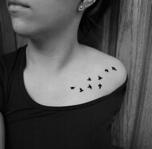Silhouette Little Flying Birds Tattoo On Girl Left Collar Bone