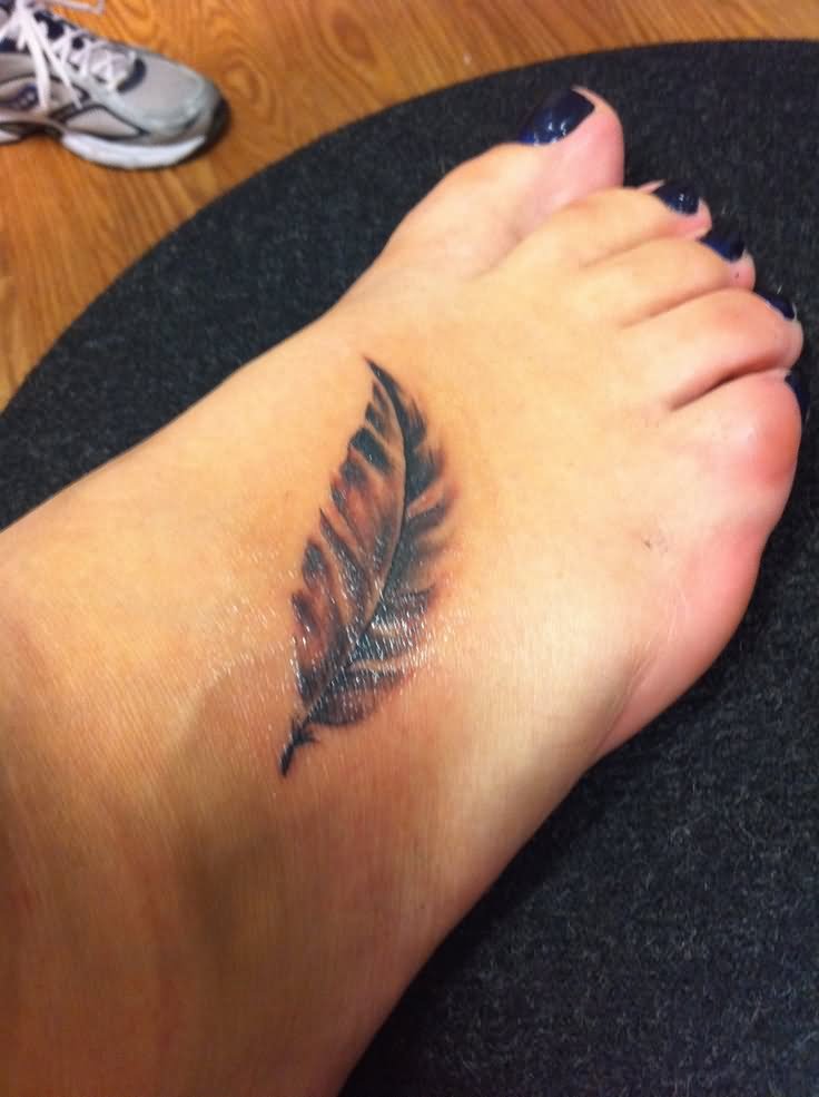 Simple Black Ink Feather Tattoo On Girl Right Foot