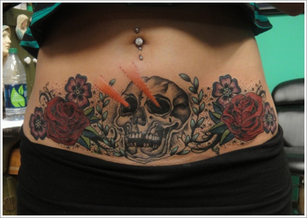 Skull With Flowers Tattoo On Girl Stomach
