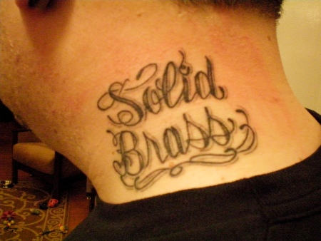 Solid Brass Words Tattoo On Man Side Neck