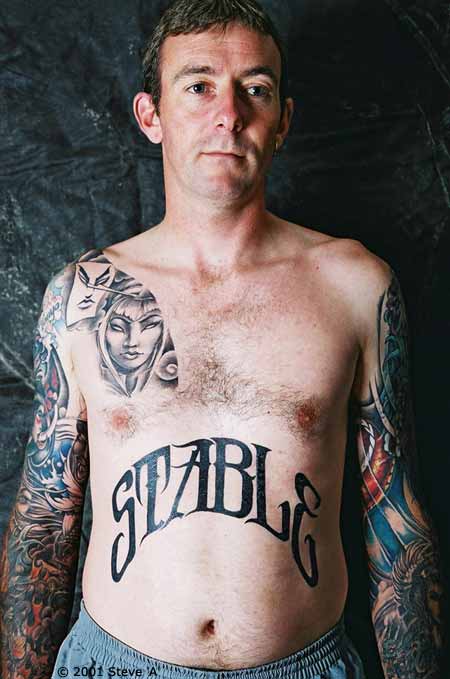 Stable Lettering Tattoo On Man Stomach