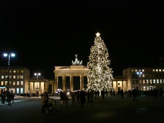 The Brandenburg Gate At Night With Lit Up Christmas Tree