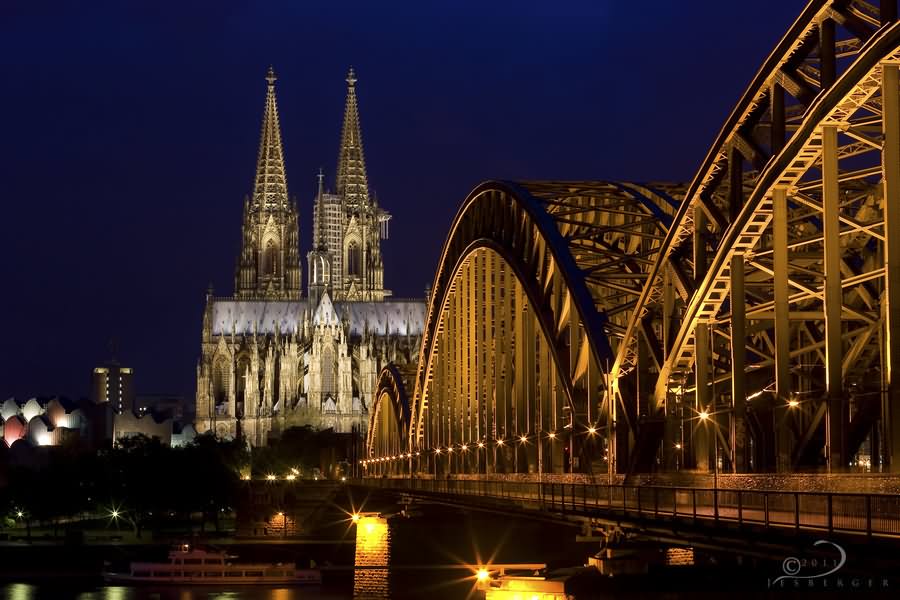 The Cologne Cathedral And Bridge Lit Up At Night