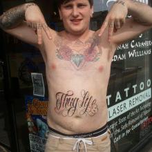 Thug Life Lettering Tattoo On Man Stomach