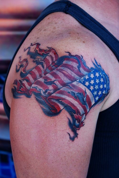 Torn American Flag Tattoo On Right Shoulder
