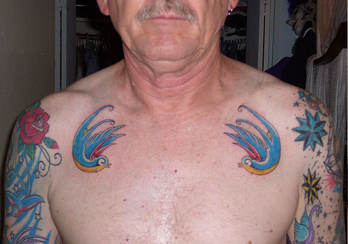 Traditional Birds Tattoo On Old Man Collar Bone